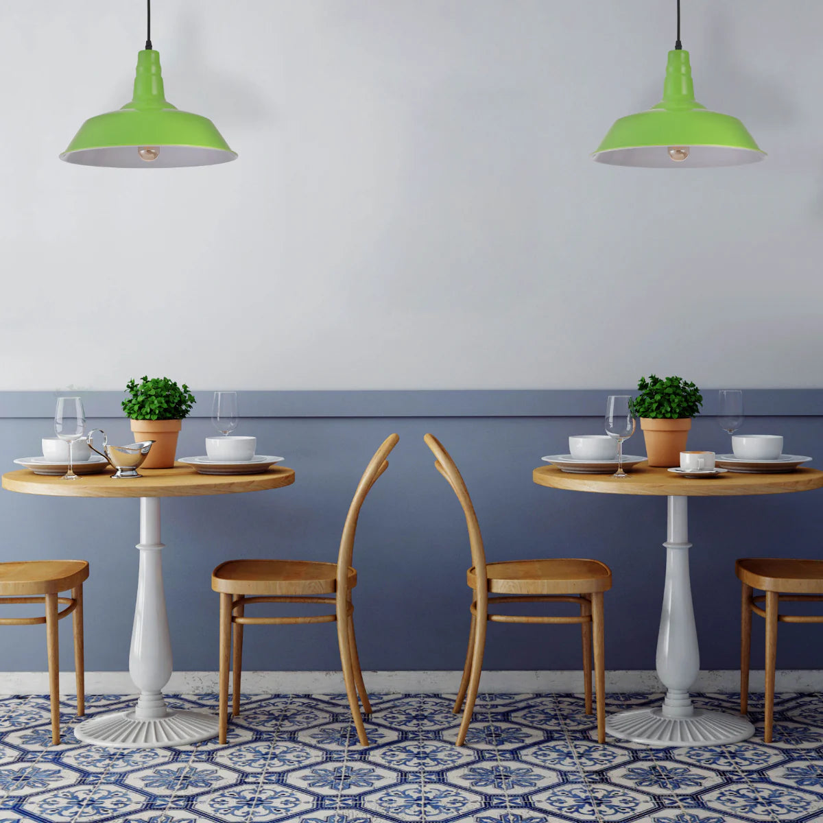 Two round tables with chairs. Green lamps above. The tables are set with tableware and plant pots. Blue tiled floor.